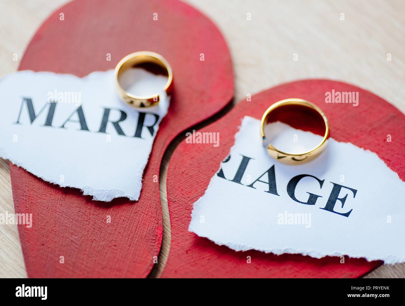 Divorce and separation concept. Two broken golden wedding rings on ...