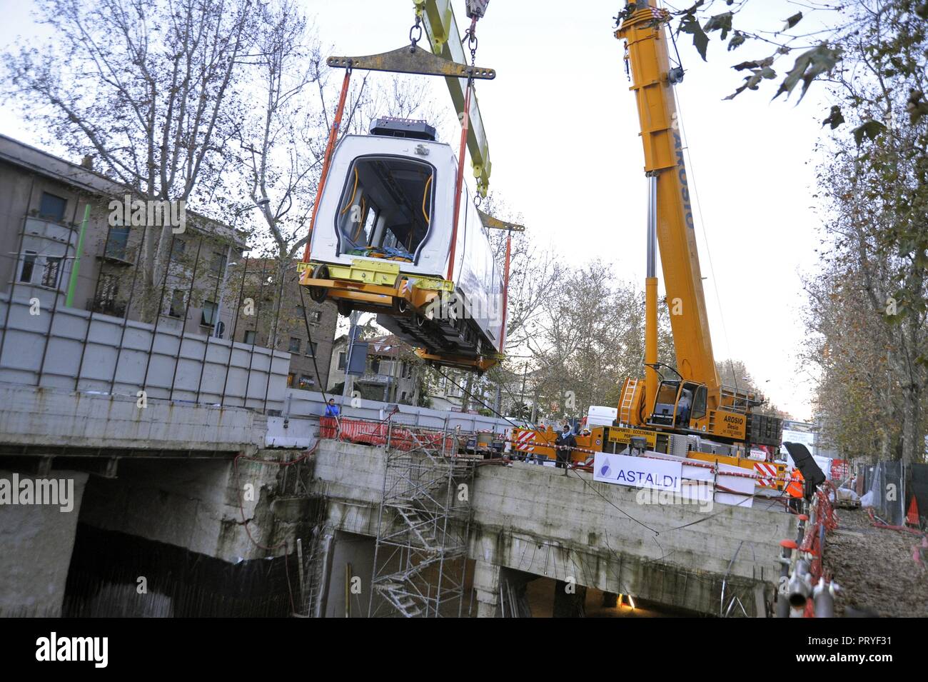 Milan (Italy), site for construction of new subway line number 5; the first car of the train is lowered into the tunnel for driving tests Stock Photo