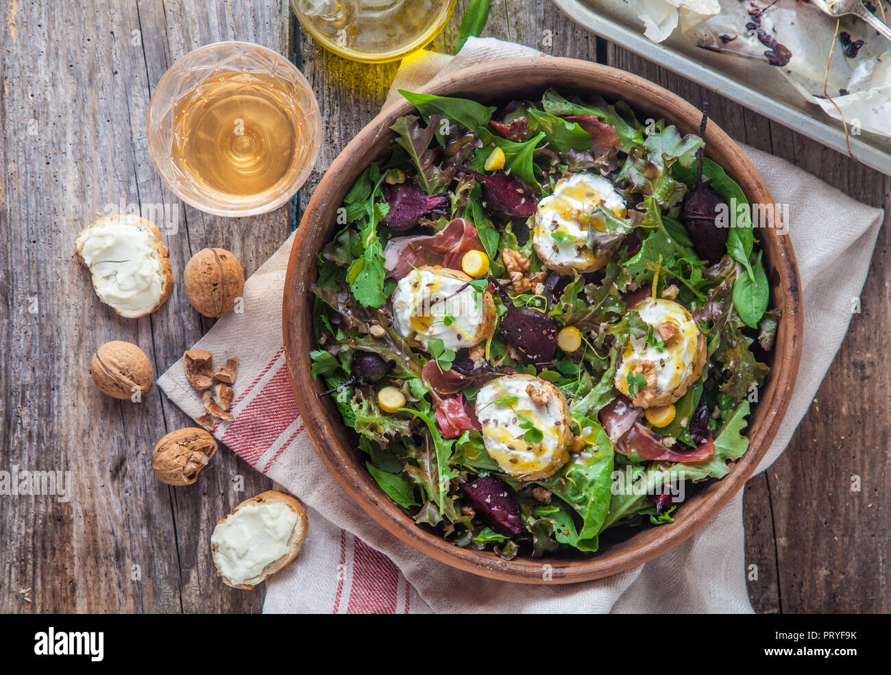 Beet and goat cheese salad in a clay pot with cider, rustic style. Stock Photo