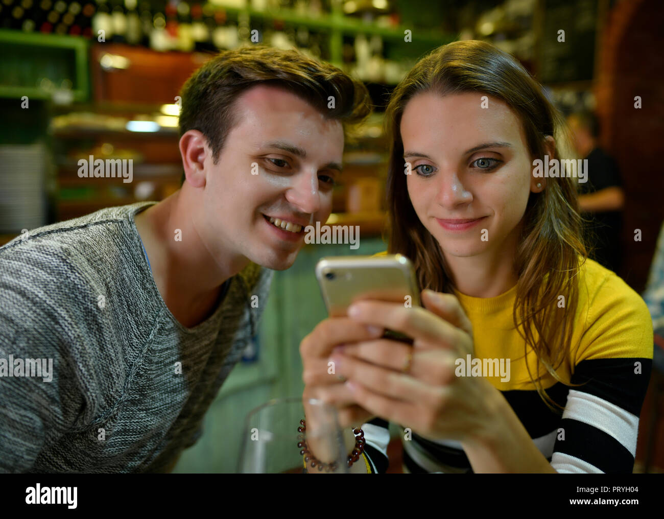 Young couple looks interested in mobile phones, Tenerife, Canary Islands, Spain Stock Photo