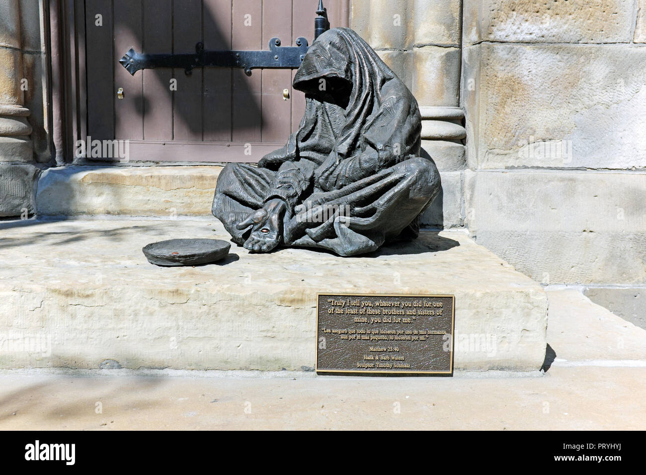 Timothy Schmalz' sculpture of Jesus as a beggar symbolizes charity and compassion for the less fortunate sits outside Old Stone Church in Cleveland OH Stock Photo