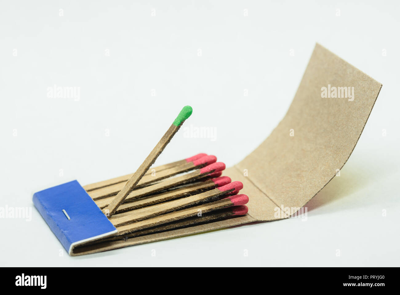 Isolated paper matchbox with all matches having red head while one sticking  out match has a green one. Conceptual image for being different from other  Stock Photo - Alamy