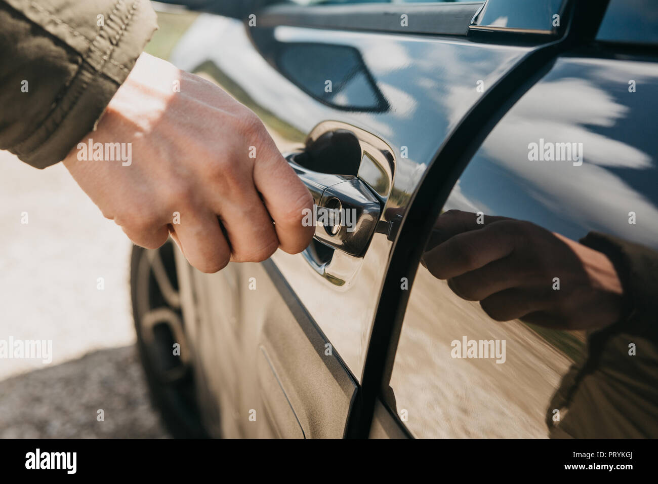 Closeup of a man's hand opens the car door with a key Stock Photo Alamy