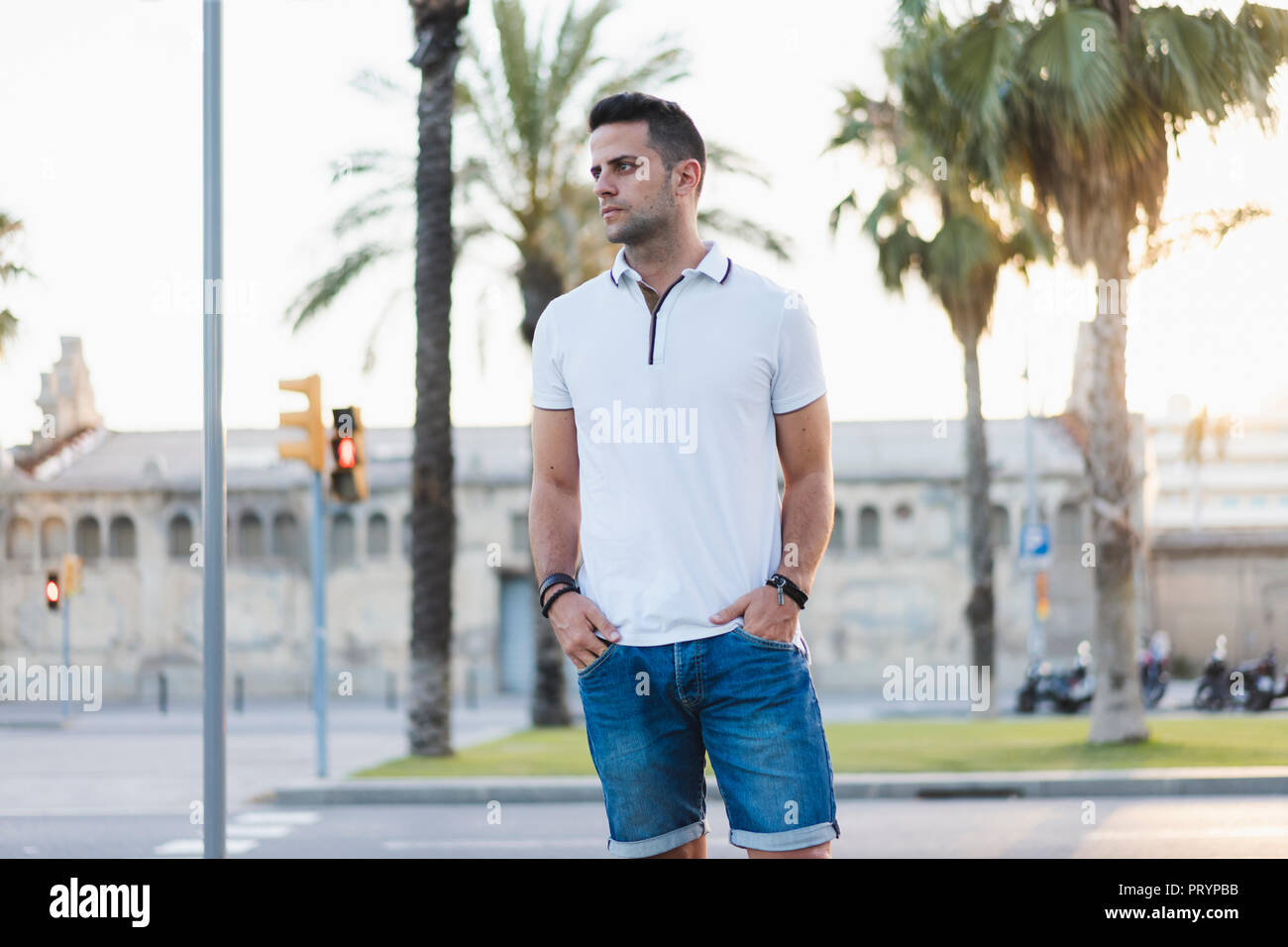 Young man standing in the street hi-res stock photography and images ...