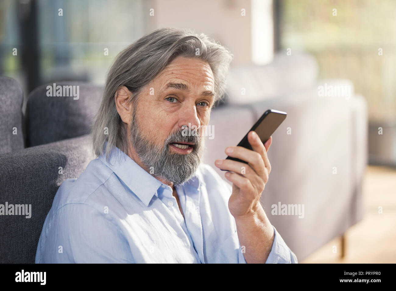 Senior man using smartphone Stock Photo