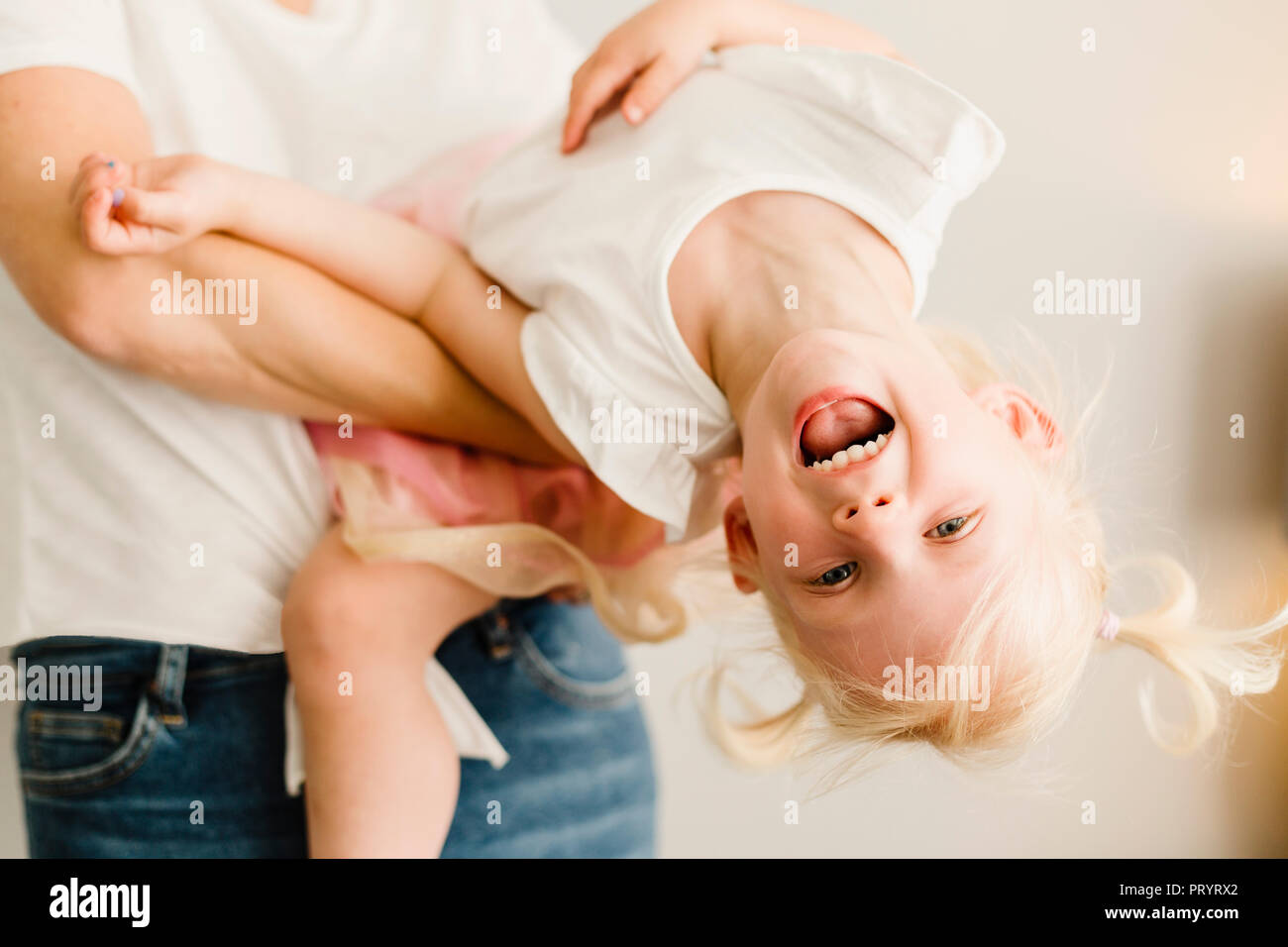 Portrait of happy little girl playing with her mother Stock Photo