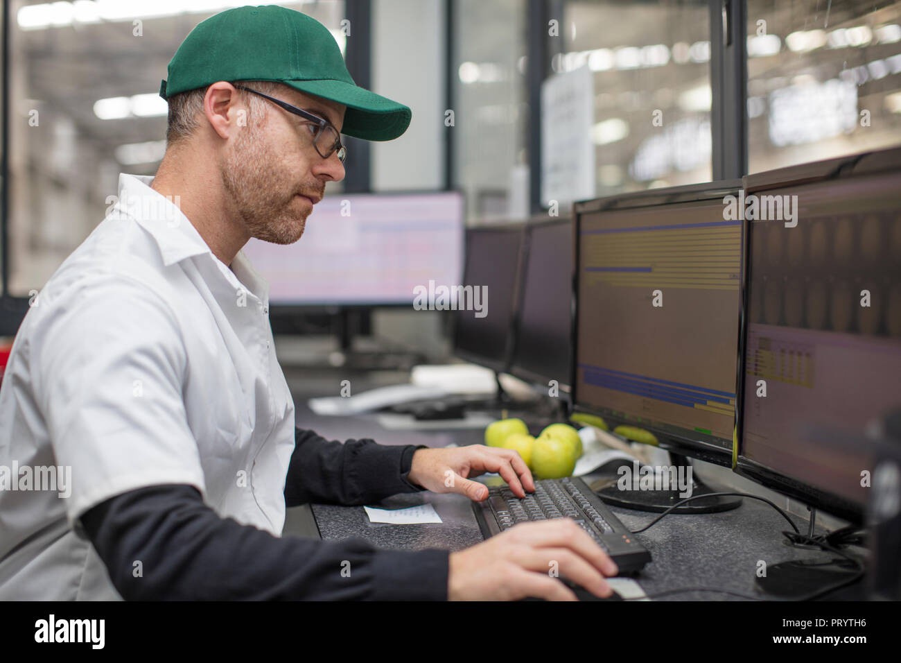Worker checking information on computer Stock Photo Alamy