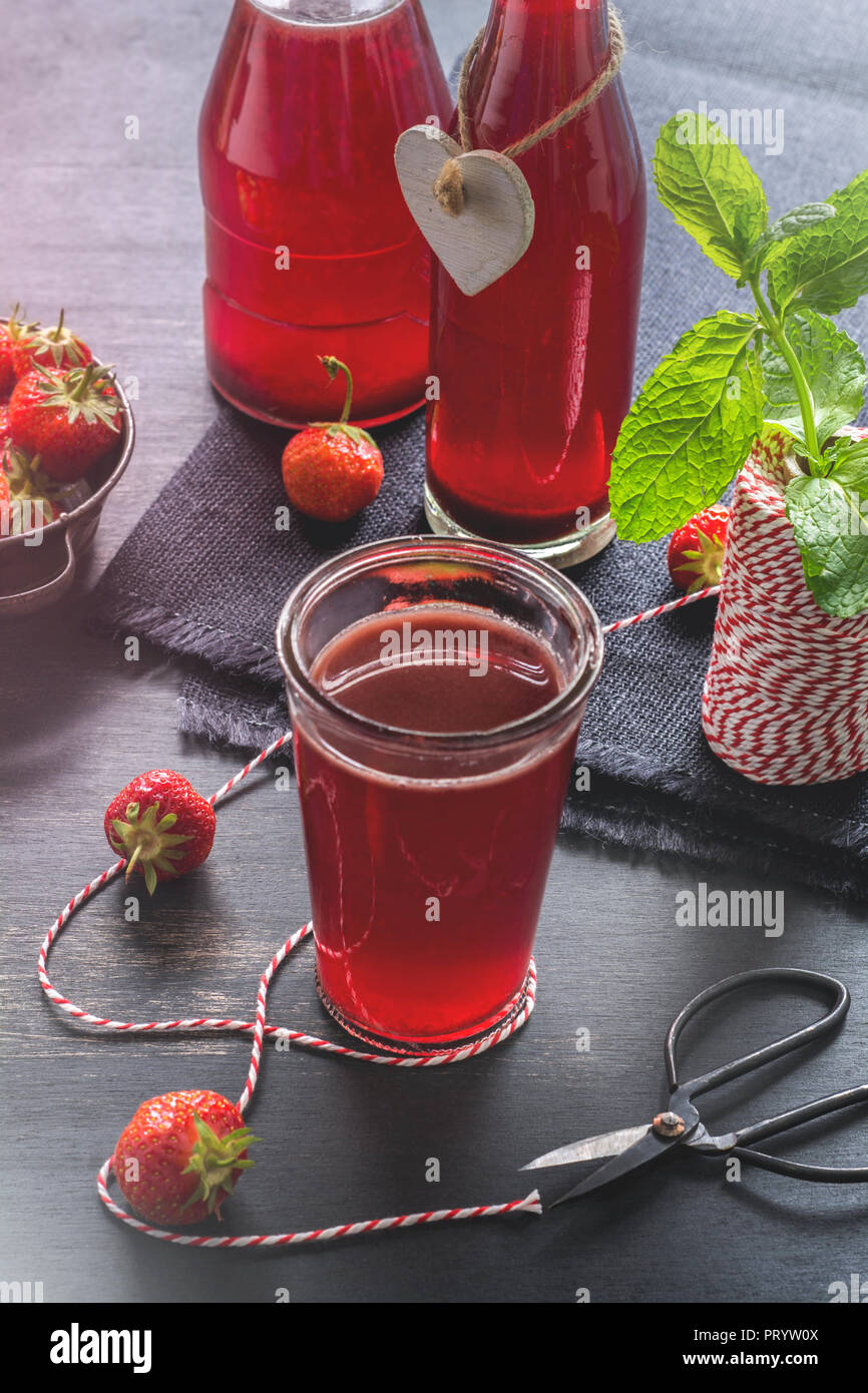 Glass and glass bottles of homemade strawberry lemonade Stock Photo Alamy