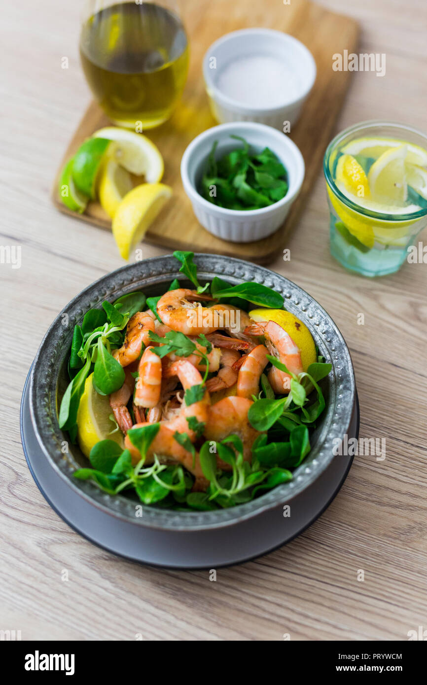 Shrimps with lamb's lettuce in bowl Stock Photo