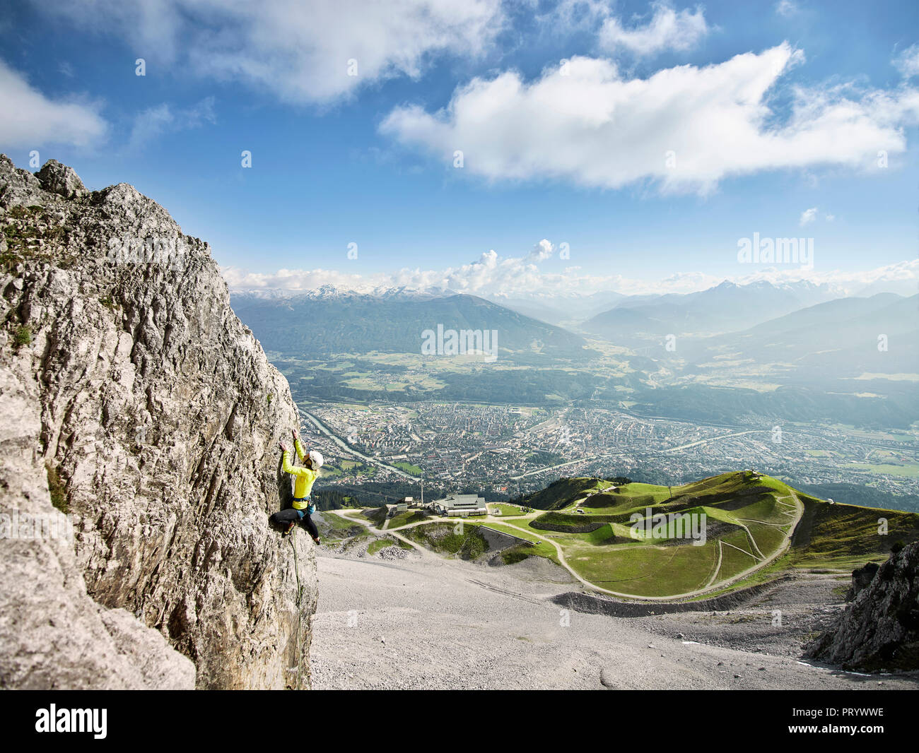 Austria, Innsbruck, Nordkette, man climbing in rock wall Stock Photo