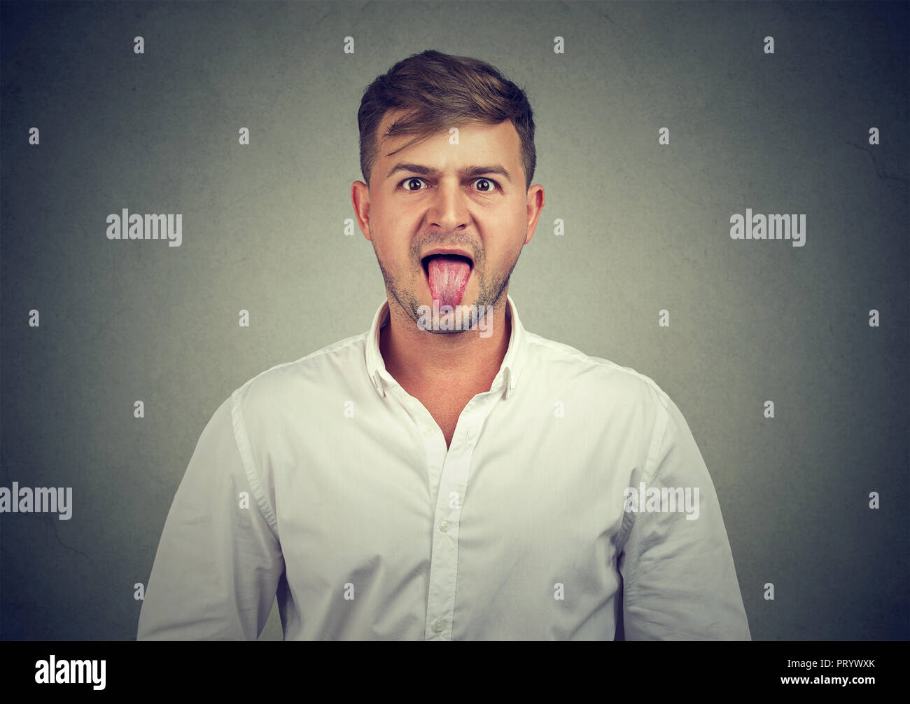 closeup-portrait-of-a-man-sticking-his-tongue-out-at-you-isolated-on