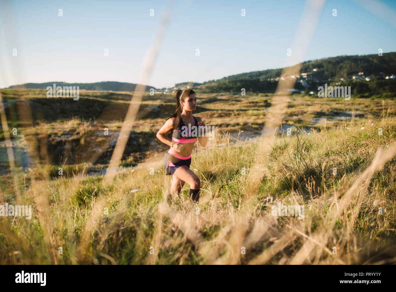 Young sportswoman training on the coast, jogging Stock Photo