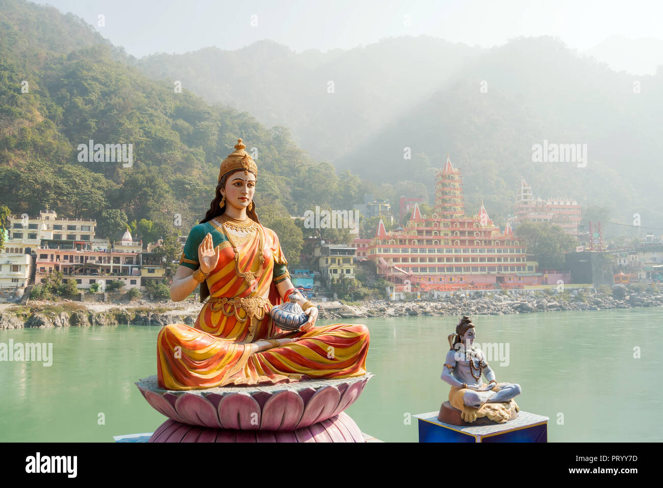 Statue of sitting goddess Parvati and Statue Shiva on the riverbank of Ganga in Rishikesh Stock Photo