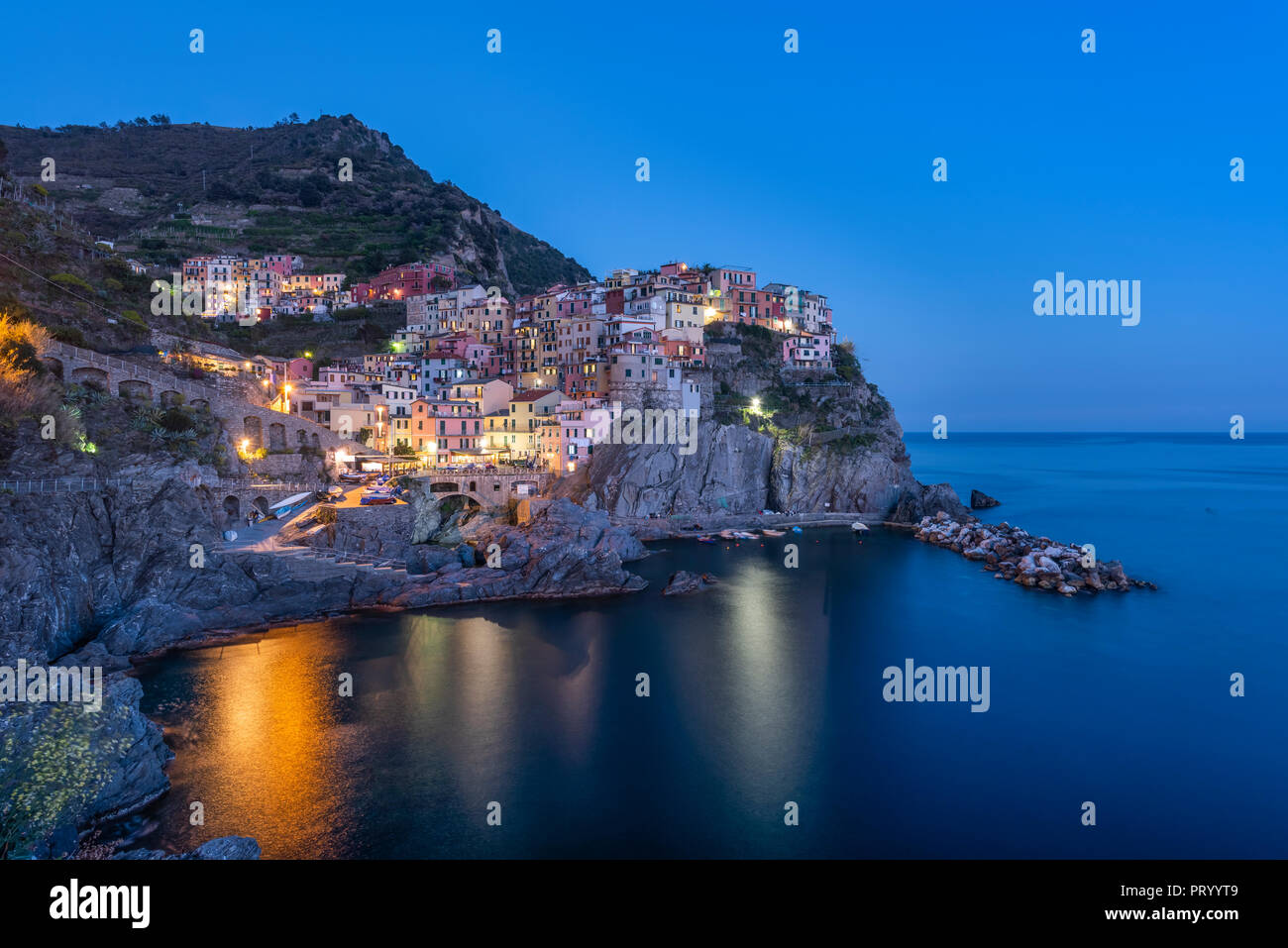 Italy, Liguria, La Spezia, Cinque Terre National Park, Manarola at blue hour Stock Photo