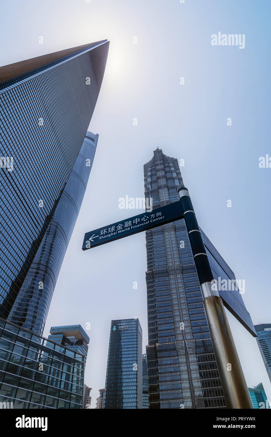 China, Shanghai, Lujiazui, skyscrapers and sign post at financial district Stock Photo