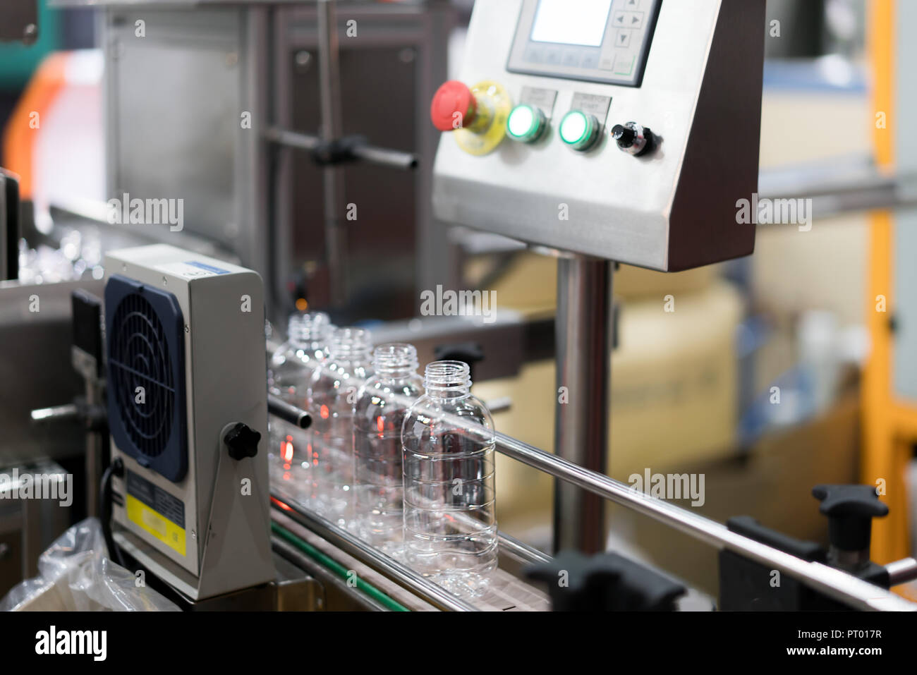 Clear Bottles transfer on Conveyor Belt System. Industrial and factory with machine technology concept. Stock Photo