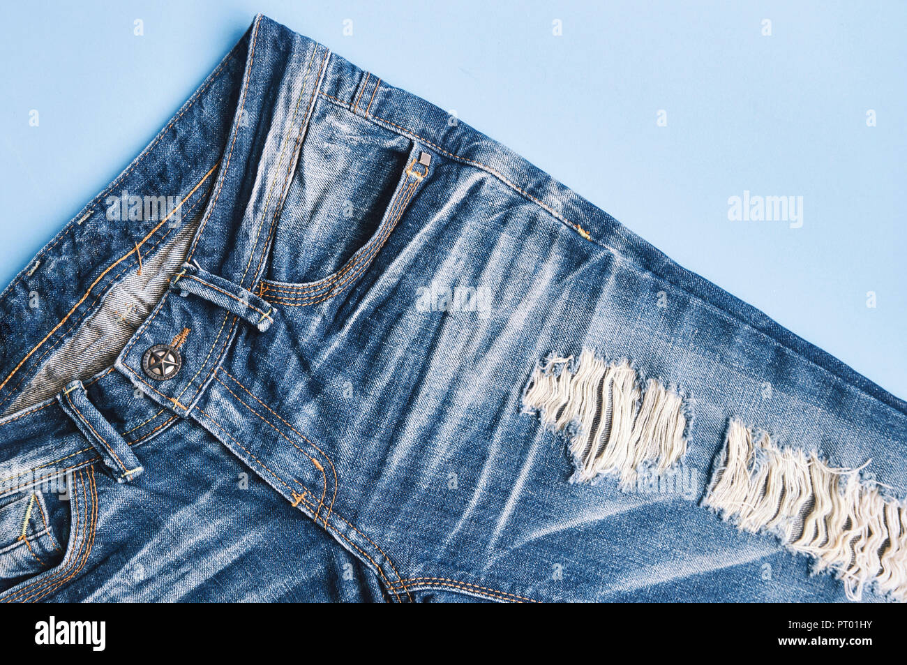 Hole and threads of denim blue jeans, Ripped and blue jeans texture Close-up Stock -