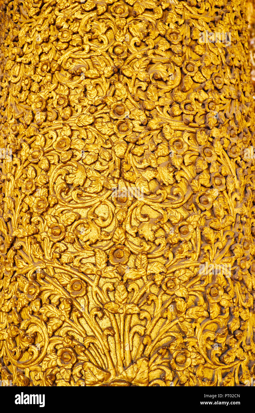 Close-up of ornate plasterwork with floral motives, covered with gilt,  Kassapa Buddha Image House of Shwedagon Zedi Daw, Yangon, Myanmar. Stock Photo