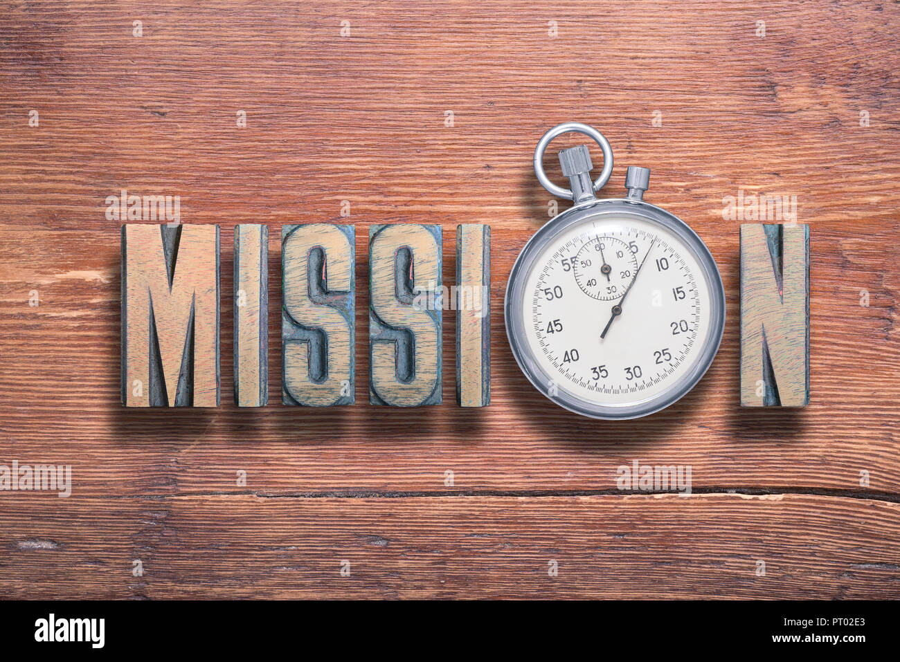 mission word combined on vintage varnished wooden surface with stopwatch inside Stock Photo