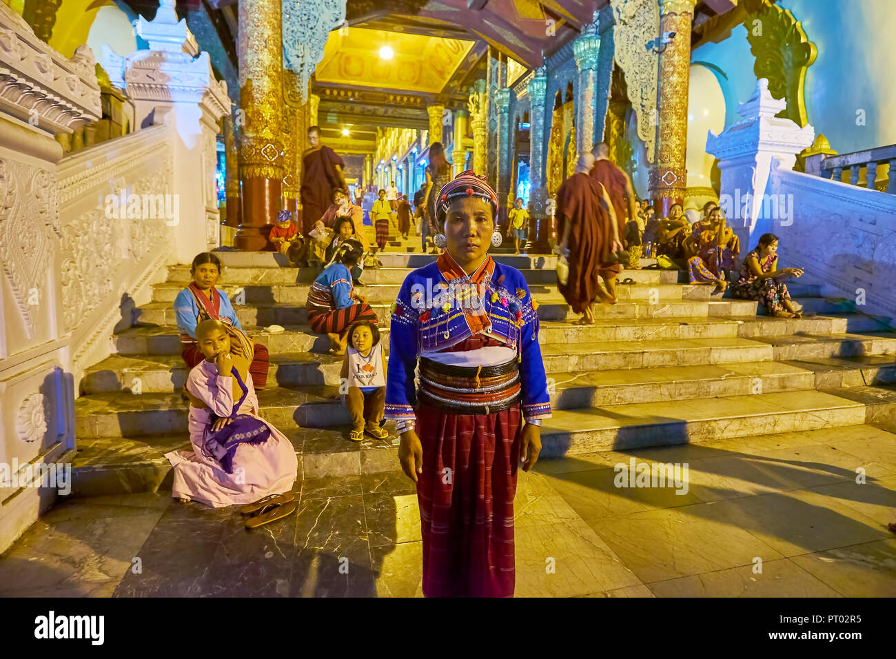 YANGON, MYANMAR - FEBRUARY 27, 2018: The portrait of a woman of Silver Palaung tribe (Kengtung), dressed in traditional attire with many silver jewelr Stock Photo