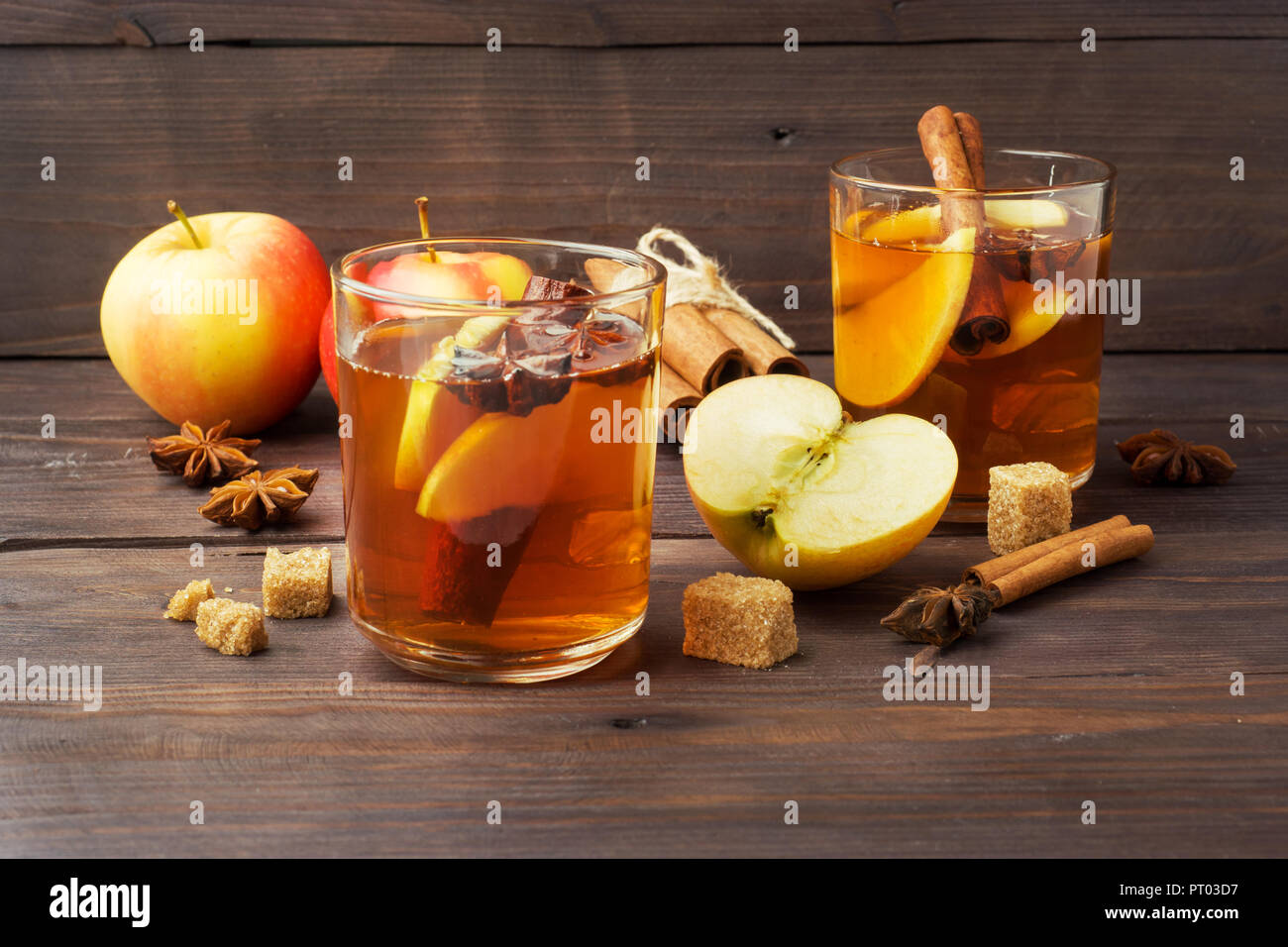 Mulled wine cider in glass mugs with cinnamon, anise and apples ...