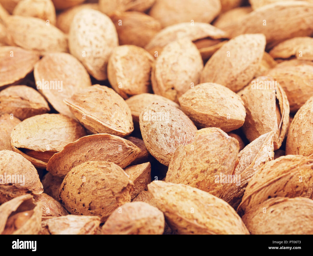 fresh raw unpeeled almonds nuts, food background Stock Photo