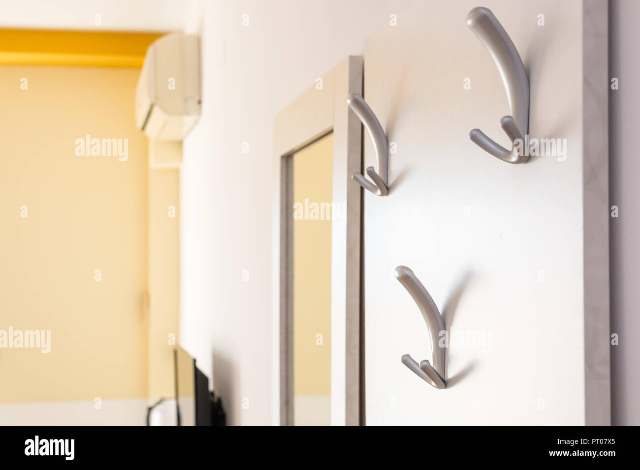 Hanging up coats hi-res stock photography and images - Alamy