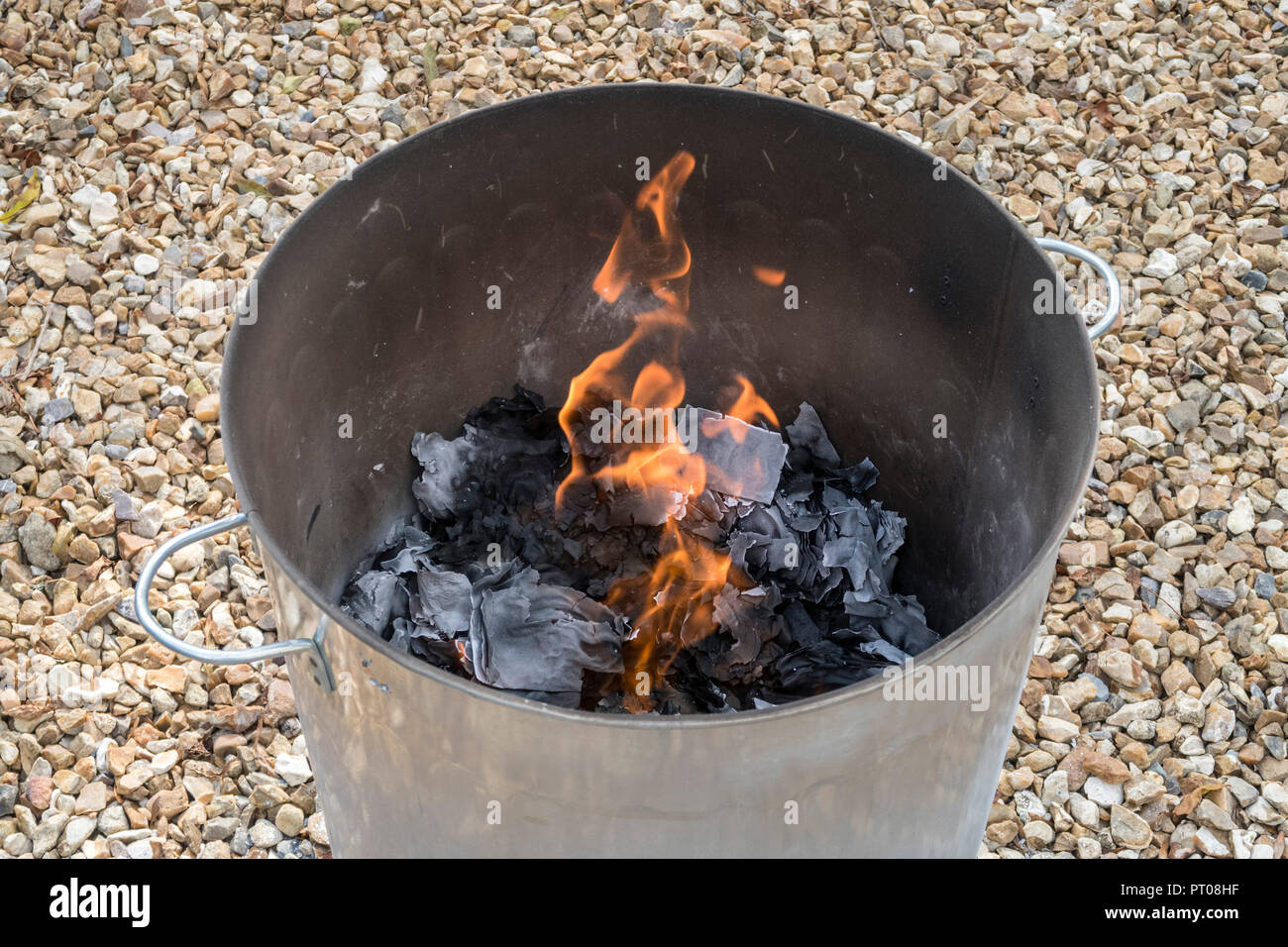 Burning garden waste and confidential waste papers in a garden