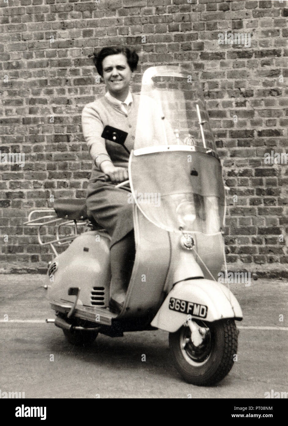 Lady on 1950s scooter circa 1950s Stock Photo
