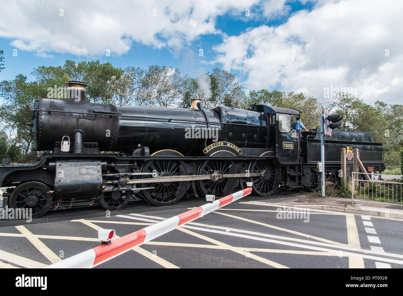 Steam train crossing Vulcan Rd, Minehead, Somerset. Stock Photo