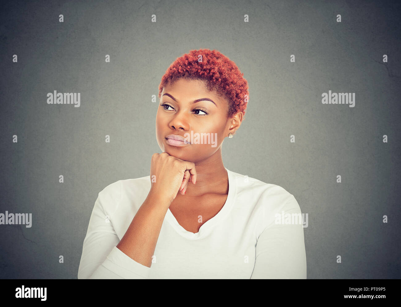Woman thinking. Portrait of a serious beautiful young woman looking away Stock Photo