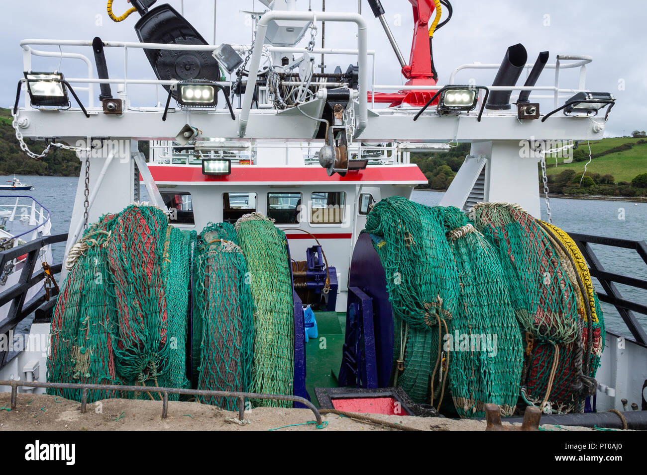 fishing nets loaded onto reels on the deck of a fishing trawler. Stock Photo
