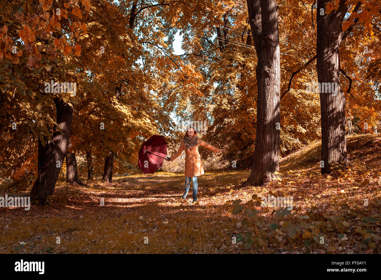 Fun in the autumn forest - Smiling girl with umbrella enjoying in ...