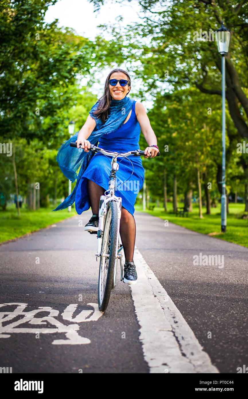 Girl with dress riding bike hires stock photography and images Alamy