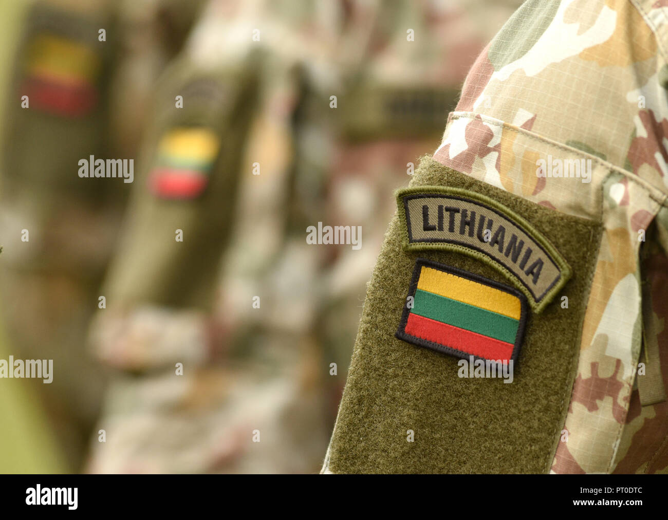 Lithuania patch flag on soldiers arm. Lithuanian military uniform. Lithuania troops Stock Photo
