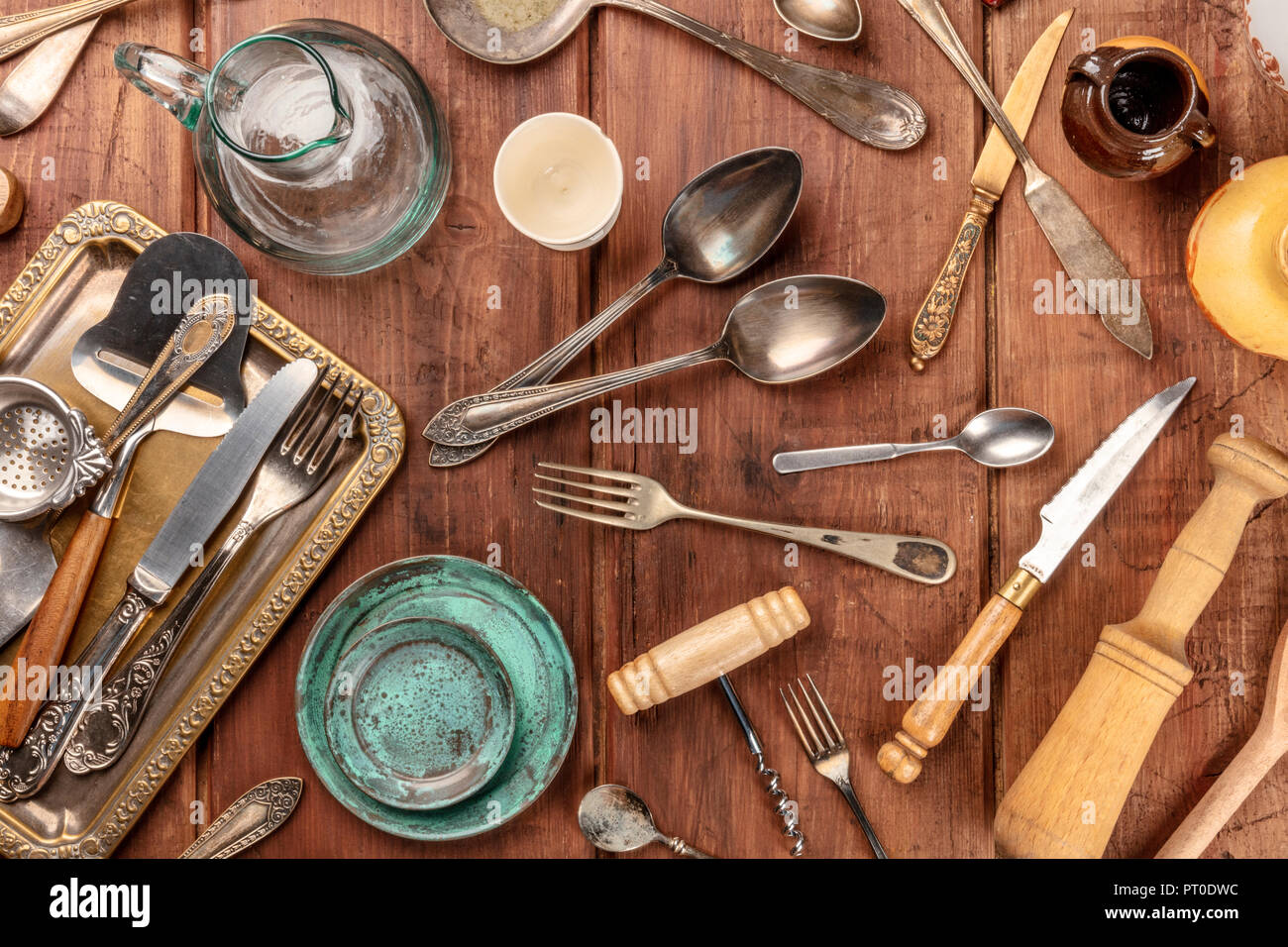 Old, vintage kitchenware. Retro equipment of cooking. Various objects for  sale at a indoor flea market. View of a display full of interesting old  things for sale. Vintage assorted second-hand objects. Stock