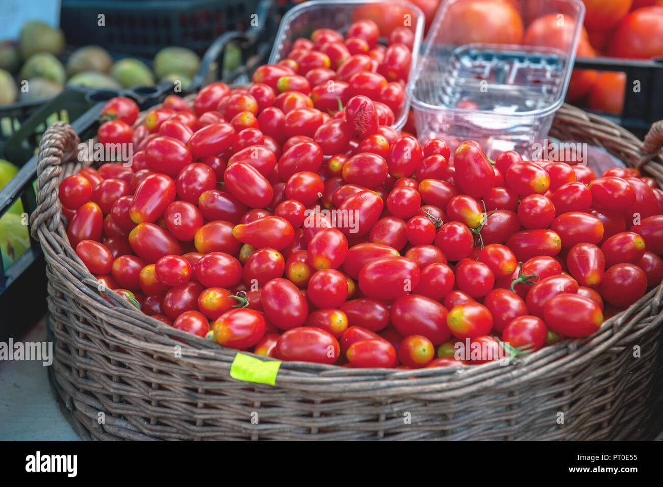 Red ripe cherry tomatoes sell at the farmer's market on a Sunny autumn ...