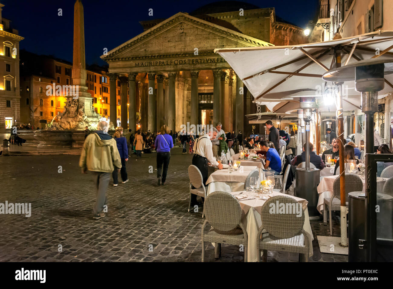Rome, Italy, march 24, 2017: Pantheon square at night with open restaurants and tourists Stock Photo