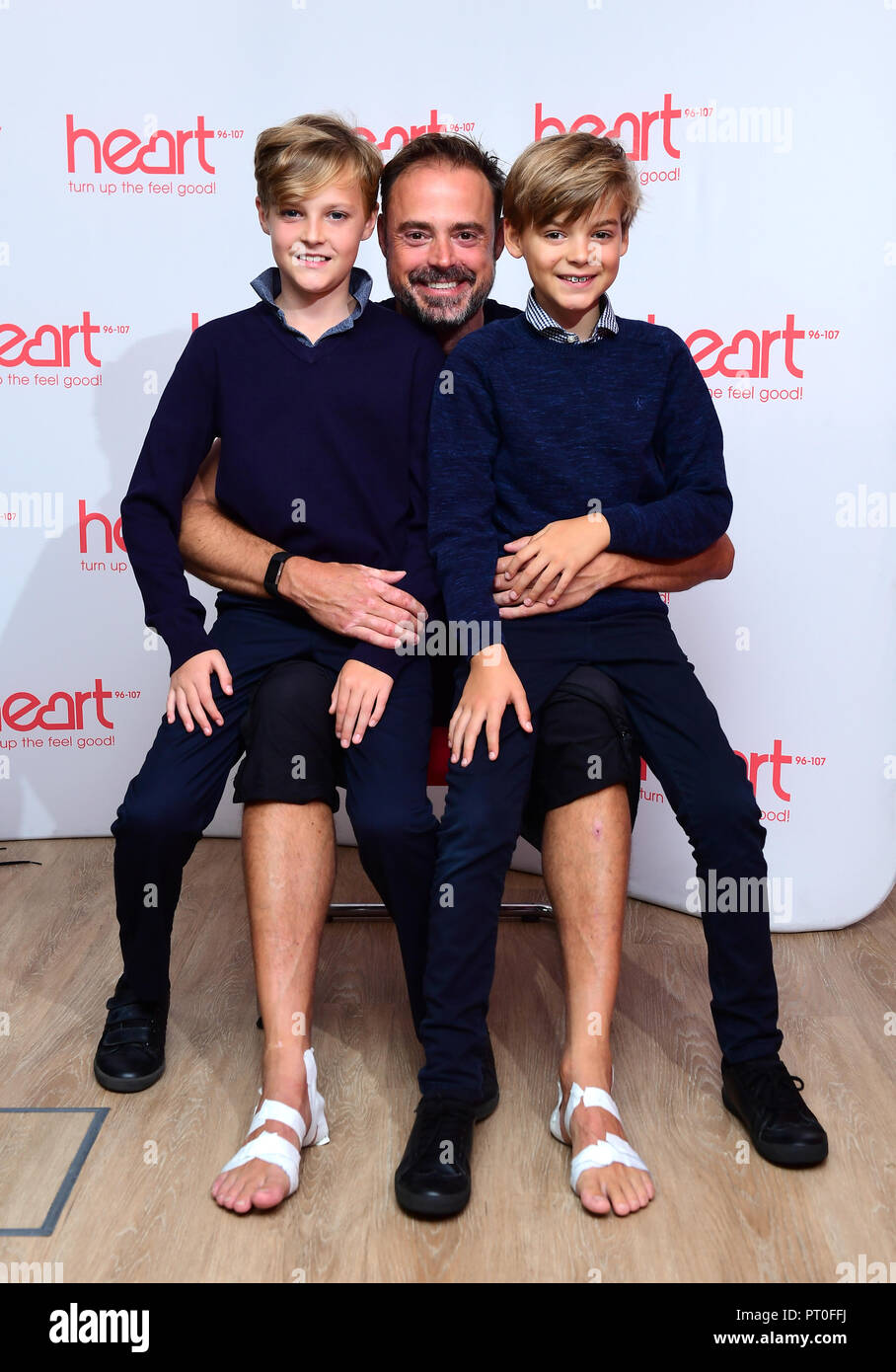 Jamie Theakston (centre) with his sons at Global's Make Some Noise Appeal Day, set up by Global, to raise money to help disadvantaged children, young people and their families across the UK. Stock Photo