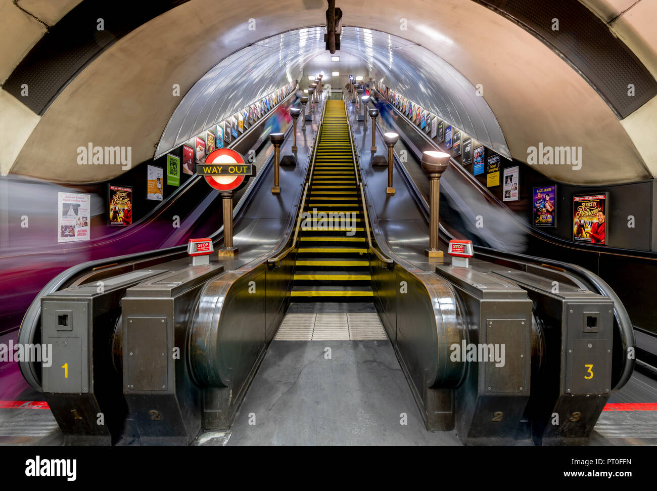 Blurred Passengers Going Up And Down On The Old Escalators At