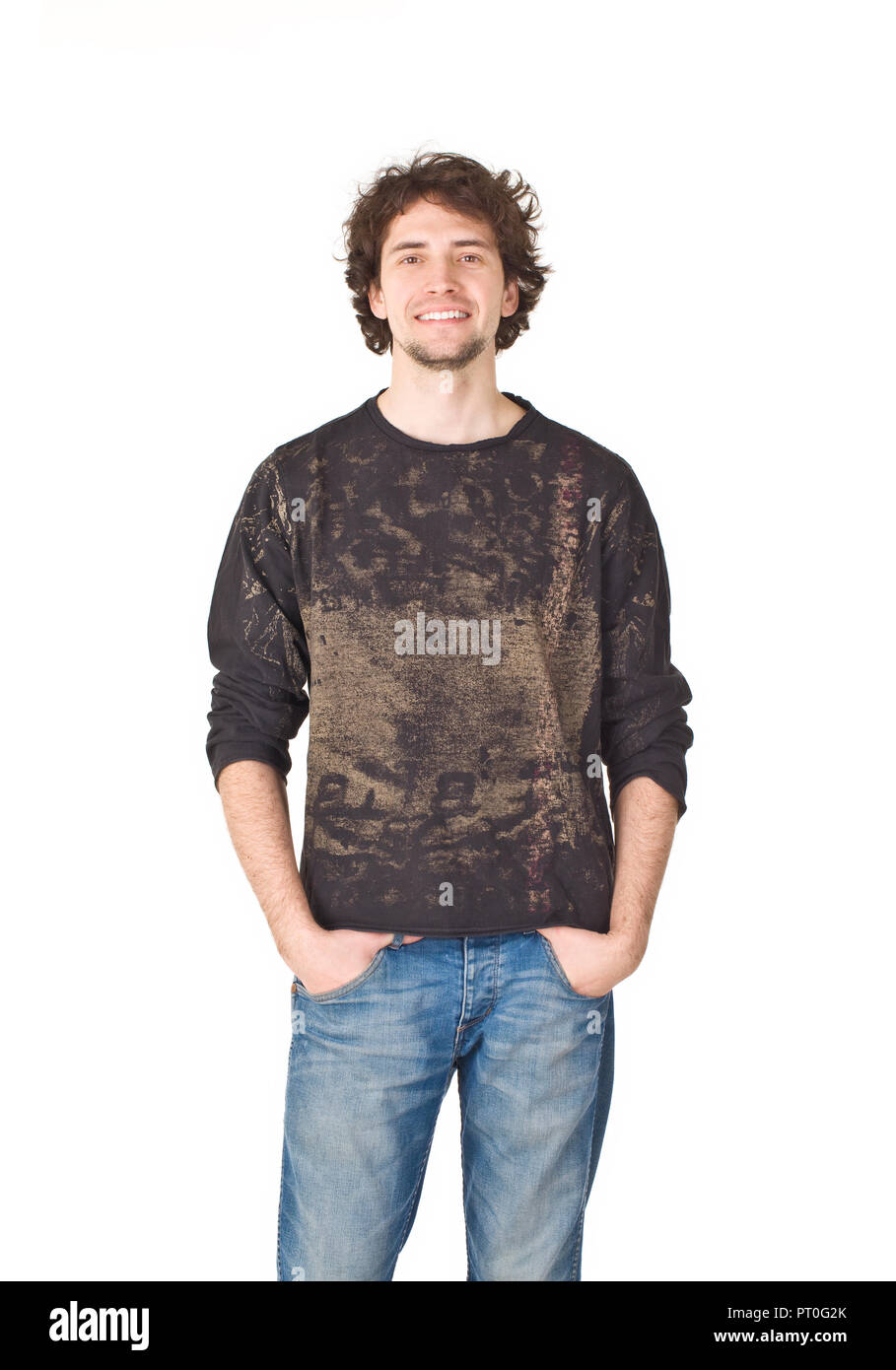 Young smiling man pointing his hands in pockets Stock Photo