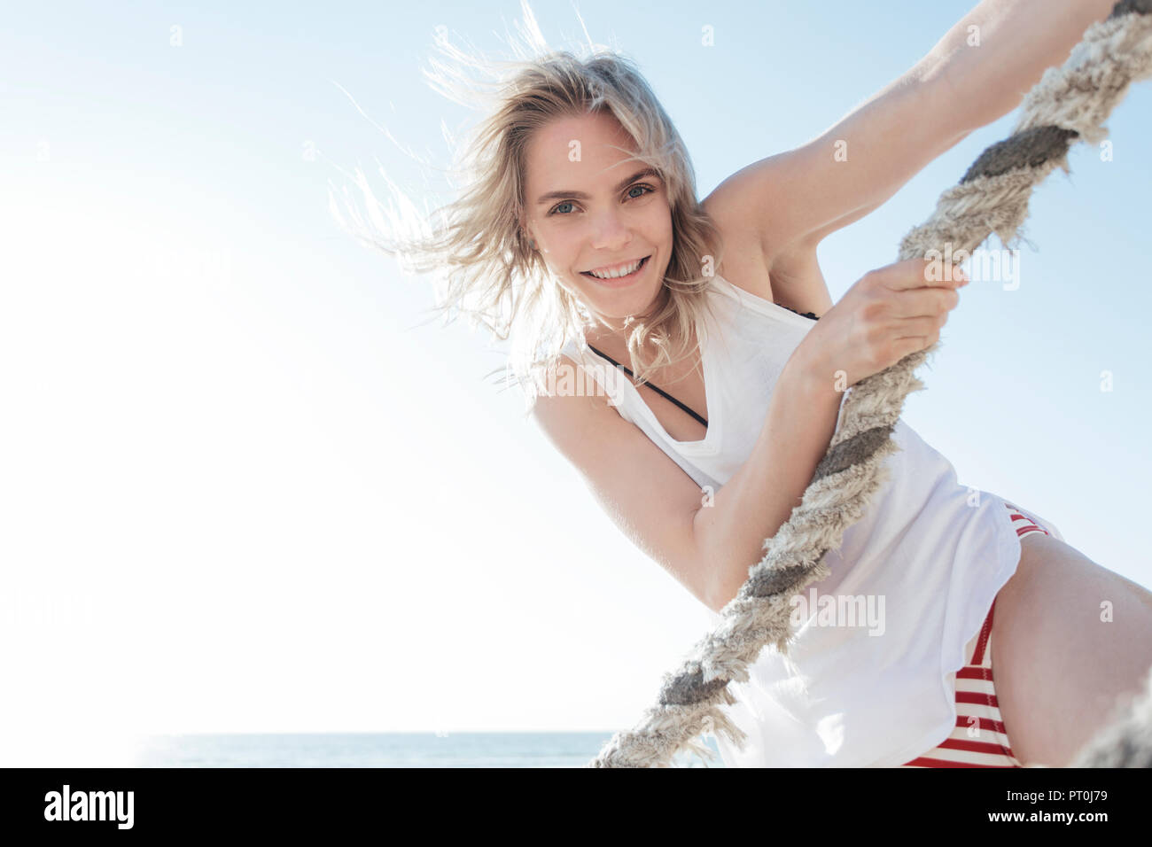 Young blond woman pulling rope beach hi-res stock photography and ...