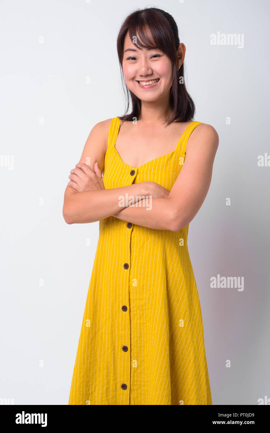Portrait of beautiful Asian woman wearing yellow dress Stock Photo - Alamy