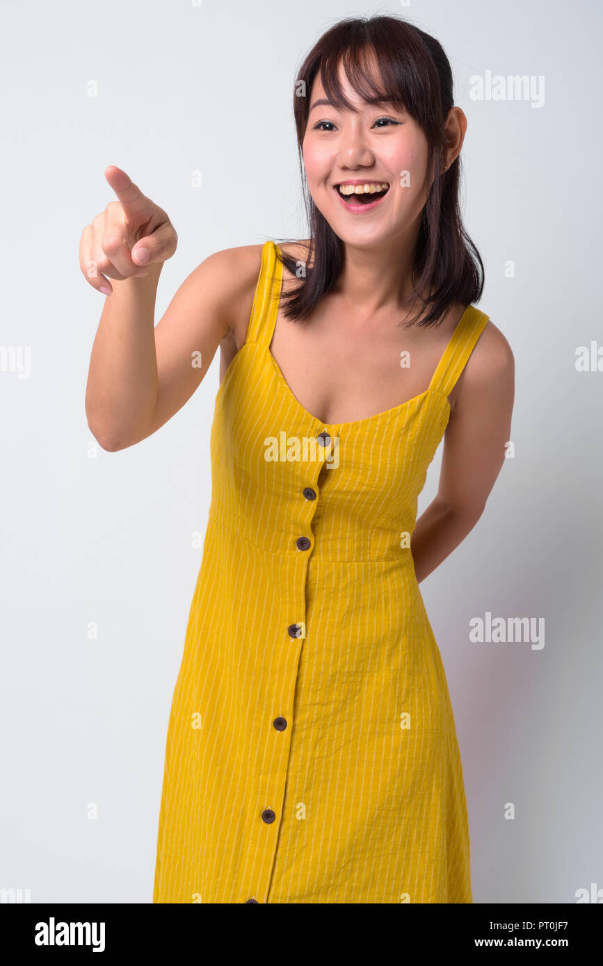 Portrait of beautiful Asian woman wearing yellow dress Stock Photo - Alamy
