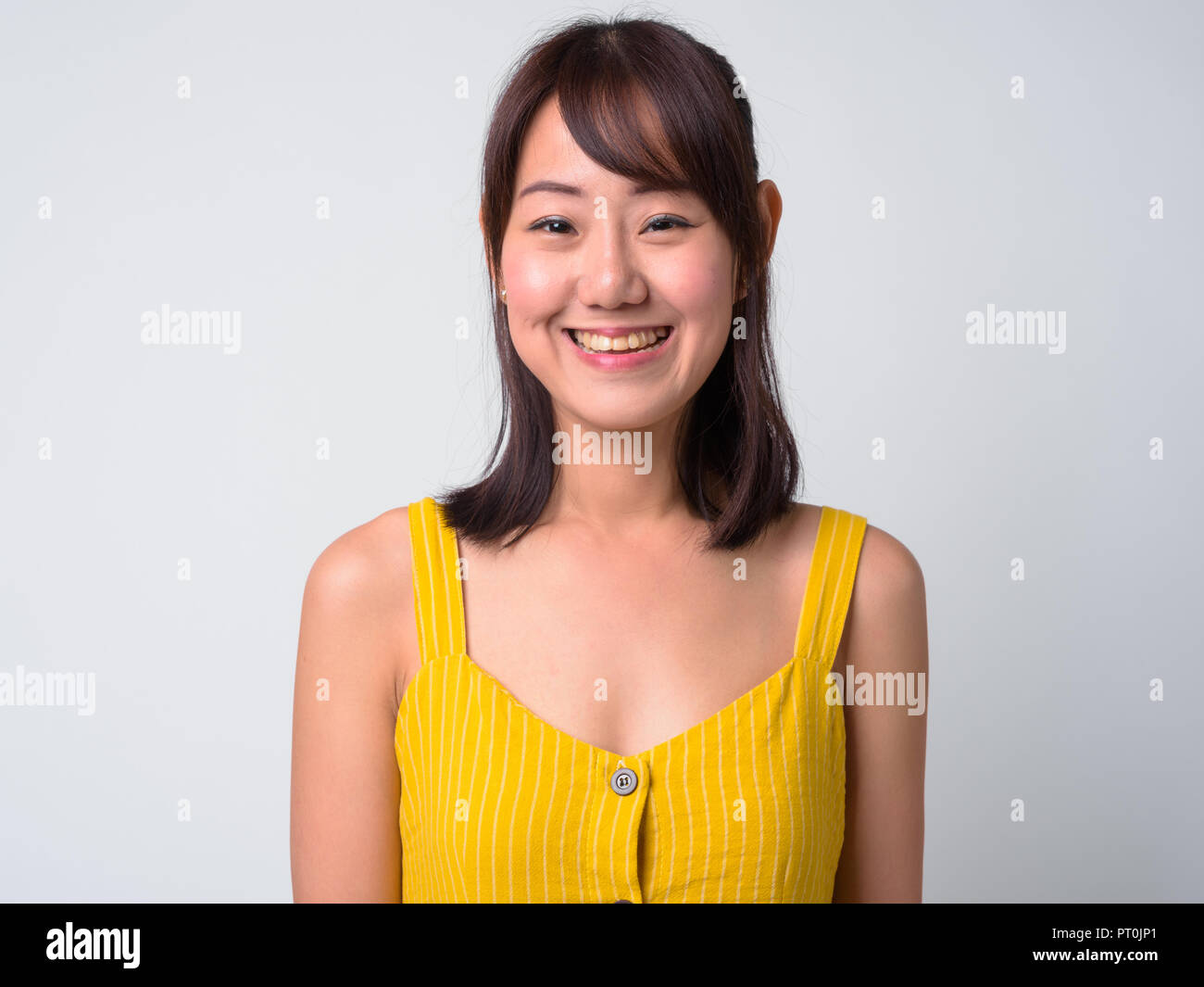 Portrait of beautiful Asian woman wearing yellow dress Stock Photo - Alamy