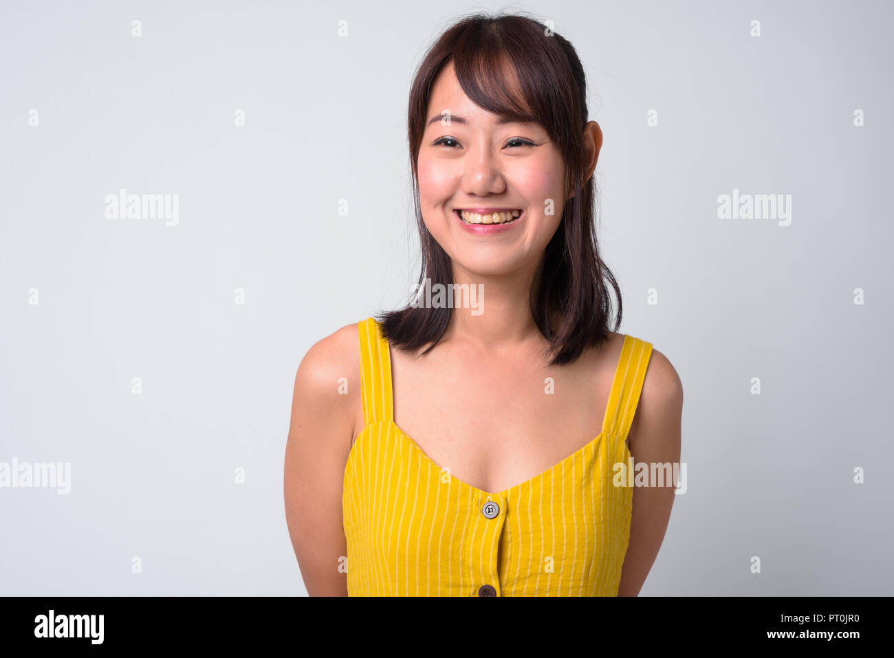 Portrait of beautiful Asian woman wearing yellow dress Stock Photo - Alamy