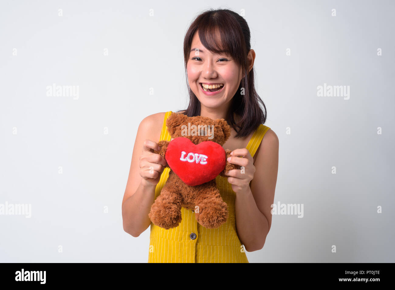 Portrait of beautiful Asian woman wearing yellow dress Stock Photo - Alamy
