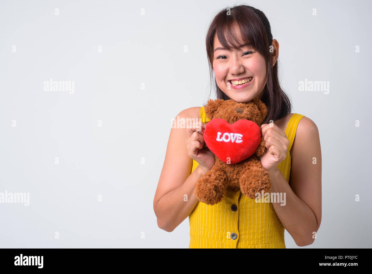 Portrait of beautiful Asian woman wearing yellow dress Stock Photo - Alamy