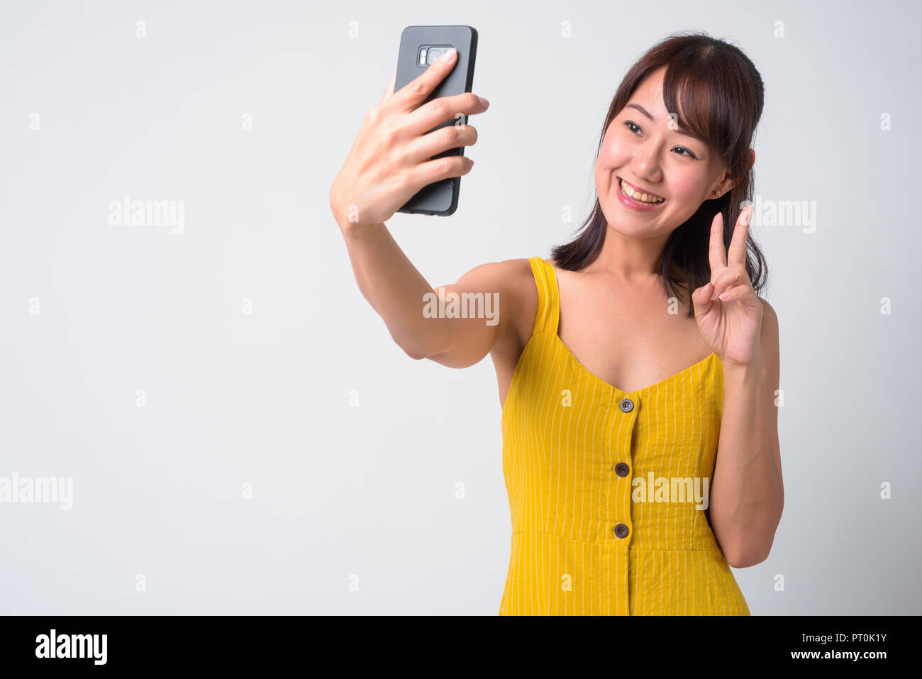 Portrait of beautiful Asian woman wearing yellow dress Stock Photo - Alamy