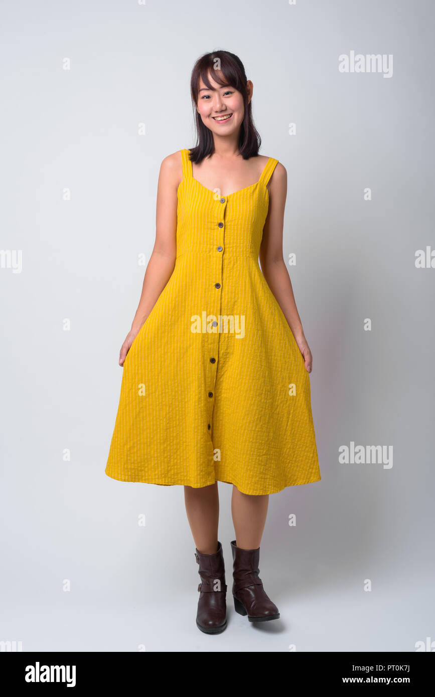 Portrait of beautiful Asian woman wearing yellow dress Stock Photo - Alamy